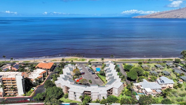 bird's eye view with a water view and a beach view