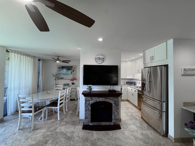 kitchen with ceiling fan, light countertops, stainless steel fridge with ice dispenser, recessed lighting, and white cabinetry