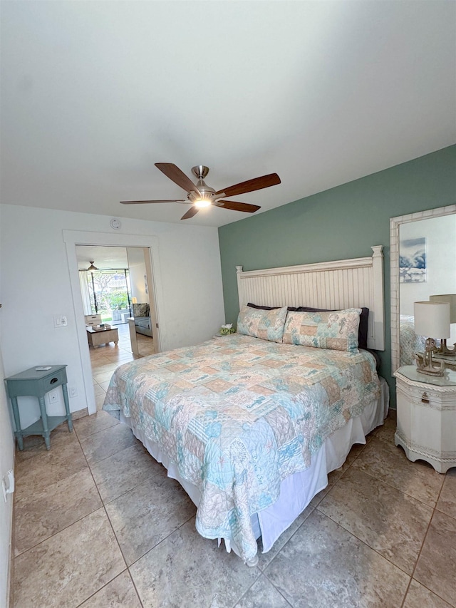 bedroom with ceiling fan and light tile patterned floors