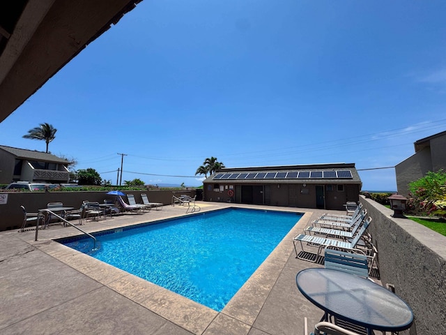 pool featuring a patio and fence