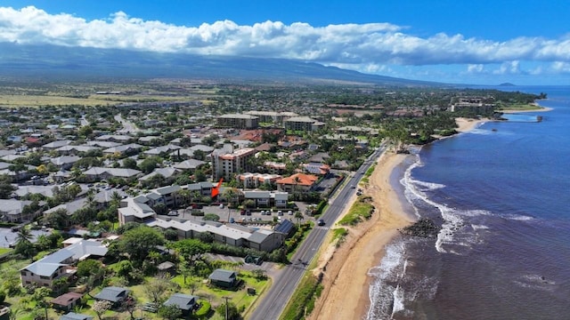 aerial view with a water view and a beach view