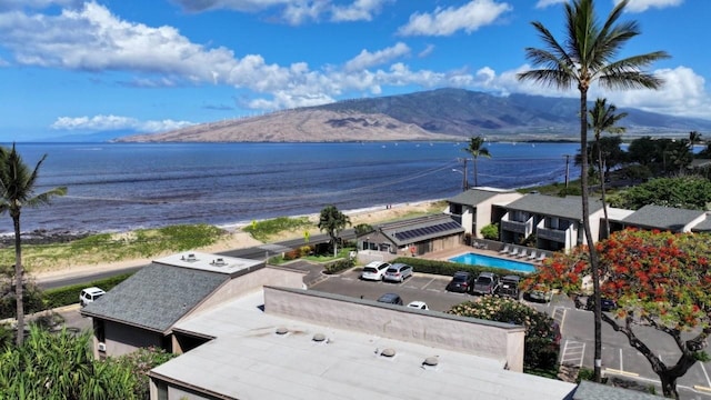drone / aerial view featuring a water and mountain view