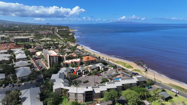 drone / aerial view featuring a water view and a view of the beach