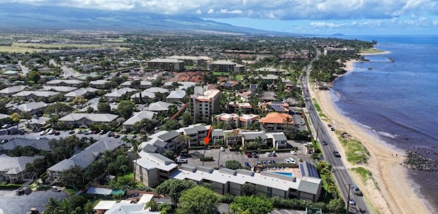drone / aerial view featuring a beach view and a water view