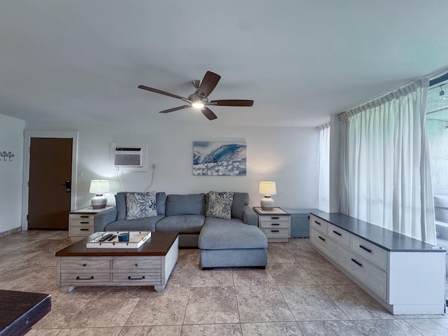 living area with an AC wall unit and ceiling fan