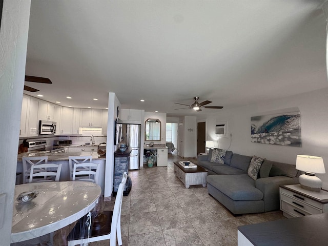 living room with ceiling fan, an AC wall unit, and light tile patterned flooring