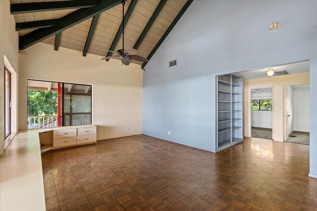 empty room with visible vents, beamed ceiling, and high vaulted ceiling