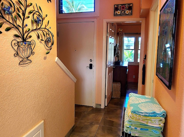 entryway featuring dark tile patterned flooring