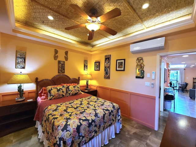 bedroom featuring ceiling fan, an AC wall unit, ornamental molding, and a tray ceiling