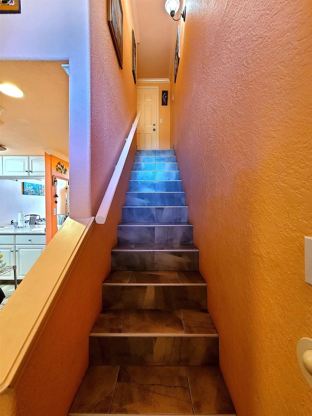 stairway featuring tile patterned flooring