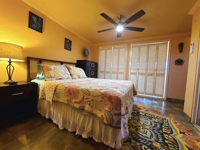 bedroom with ceiling fan, crown molding, and dark tile patterned flooring