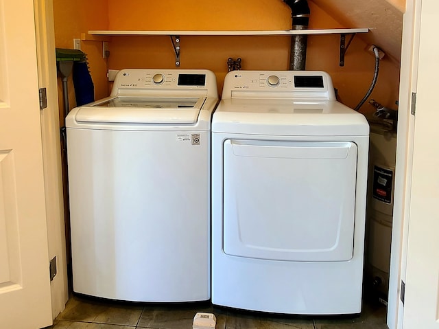 laundry area featuring tile patterned flooring and washing machine and dryer