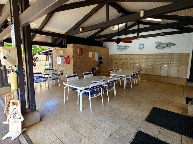 interior space with wooden walls, high vaulted ceiling, wooden ceiling, beamed ceiling, and a mail area