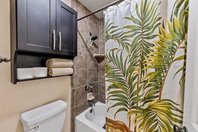 bathroom featuring shower / tub combo and toilet