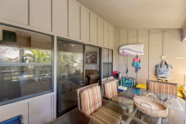 exterior space featuring wood walls and vaulted ceiling