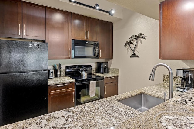 679 S Kihei Rd Unit D205, Kihei, HI 96753 - kitchen featuring light stone counters, a sink, a textured wall, and black appliances