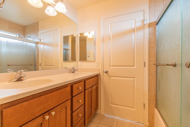 bathroom with tile patterned flooring, vanity, and combined bath / shower with glass door