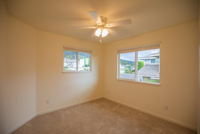 unfurnished room with ceiling fan and carpet flooring