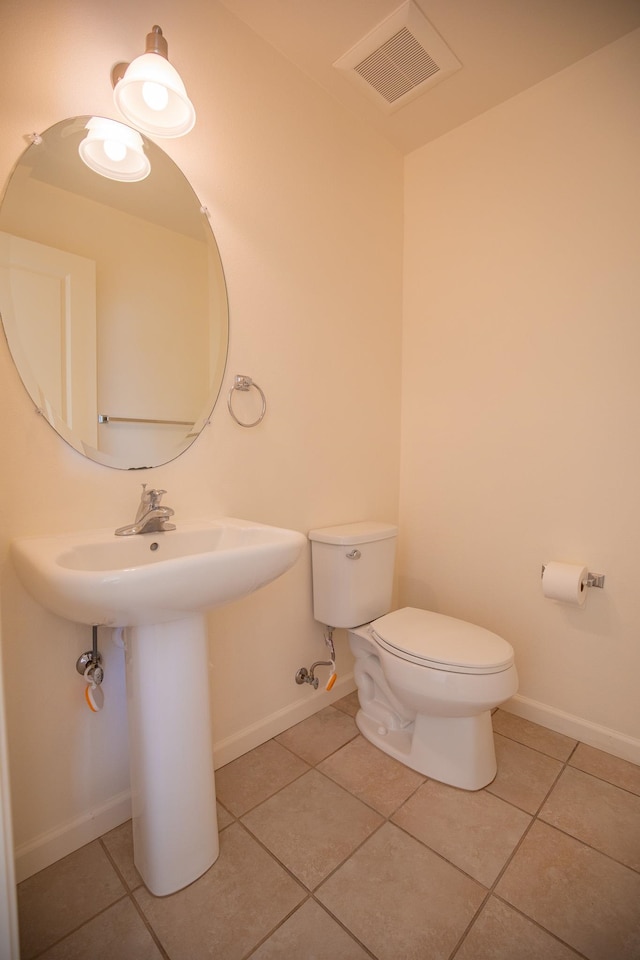 bathroom featuring toilet and tile patterned floors