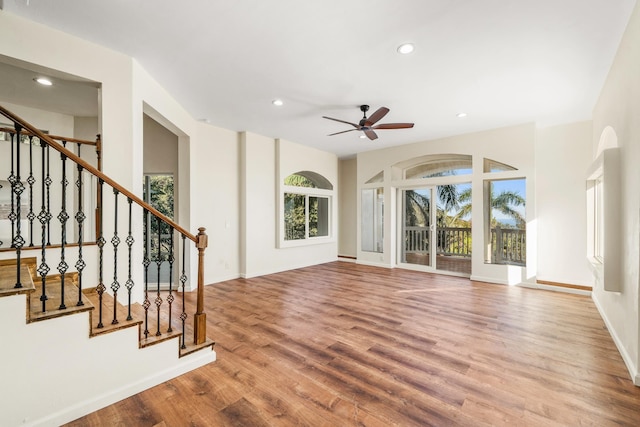 unfurnished living room with light hardwood / wood-style flooring and ceiling fan