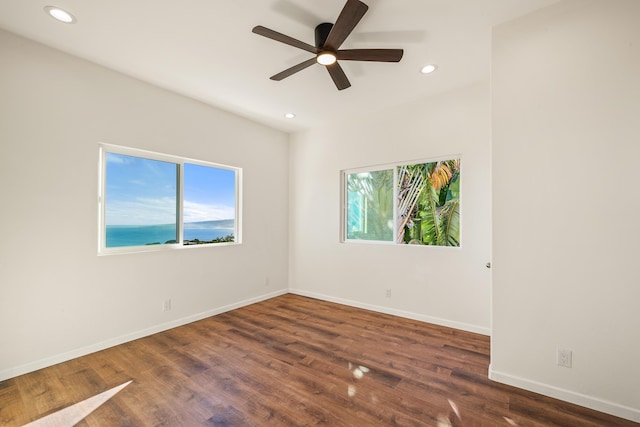 spare room with ceiling fan and dark wood-type flooring