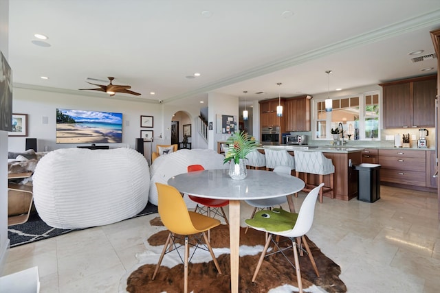 2335 Hihimanu St Unit 117, Kihei, HI 96753 - dining area featuring arched walkways, a ceiling fan, ornamental molding, and recessed lighting