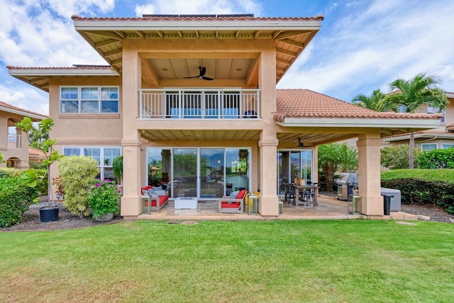 2335 Hihimanu St Unit 117, Kihei, HI 96753 - rear view of property featuring a balcony, a ceiling fan, a lawn, a patio area, and a tiled roof