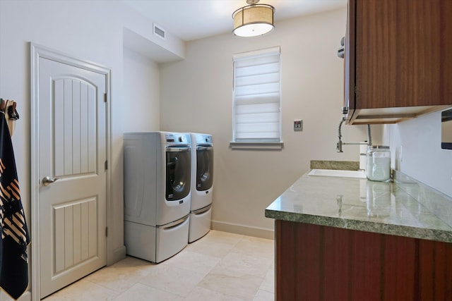 2335 Hihimanu St Unit 117, Kihei, HI 96753 - laundry area with washing machine and clothes dryer, cabinet space, and light tile patterned flooring