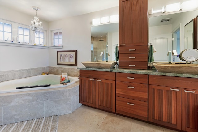 2335 Hihimanu St Unit 117, Kihei, HI 96753 - full bath featuring a garden tub, double vanity, a shower stall, a chandelier, and tile patterned floors
