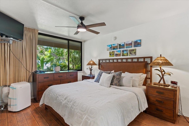 bedroom with hardwood / wood-style flooring and ceiling fan