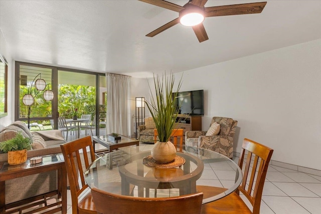 dining space with ceiling fan and light tile floors