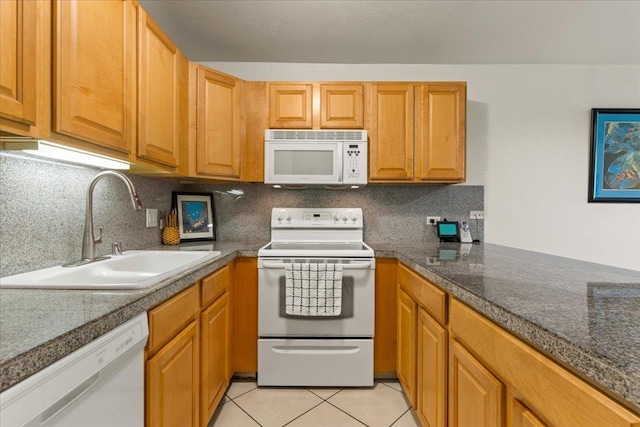 kitchen with backsplash, sink, white appliances, and light tile floors