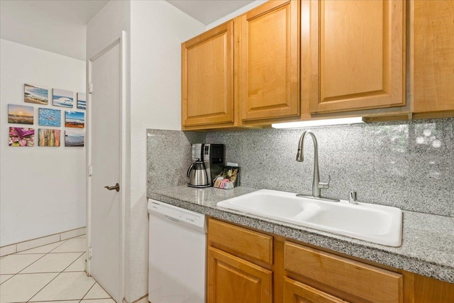 kitchen with sink, dishwasher, light tile flooring, and tasteful backsplash