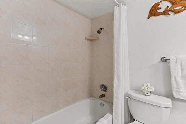 bathroom featuring shower / bathtub combination with curtain and toilet