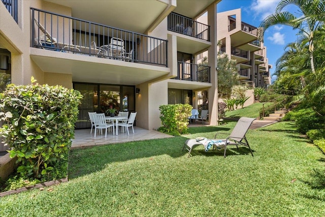 exterior space with a lawn and a patio