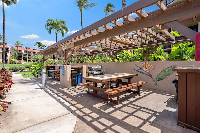 view of patio / terrace featuring a pergola and an outdoor kitchen