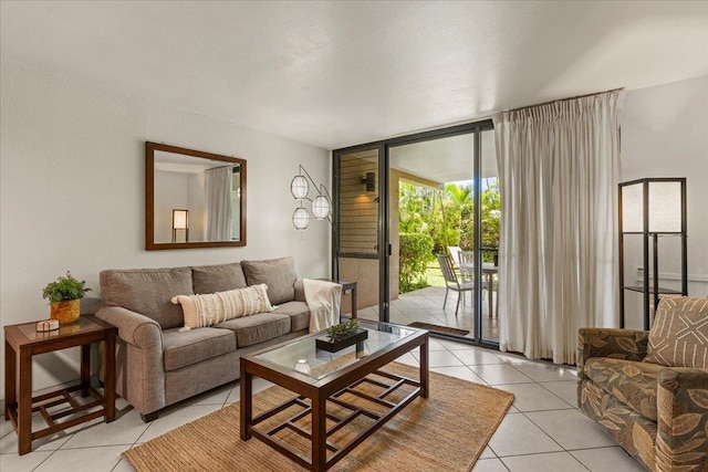 living room featuring expansive windows and light tile flooring