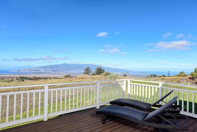 wooden terrace with a mountain view and a lawn