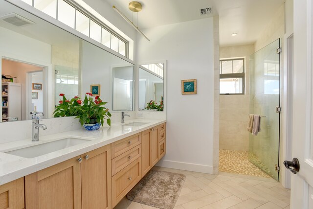 bathroom featuring vanity and a tile shower