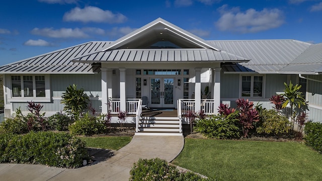 view of front facade featuring a front yard and french doors