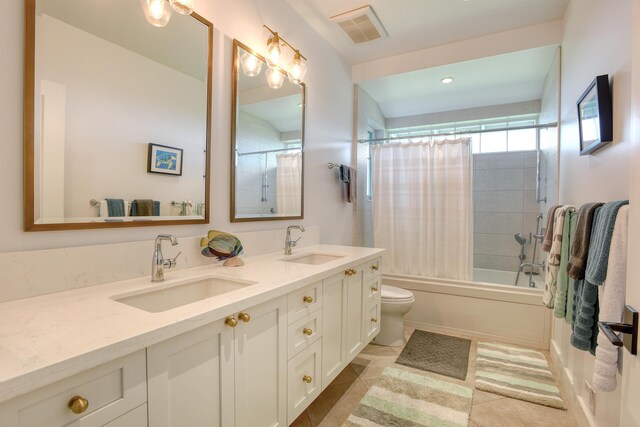 full bathroom featuring shower / bath combination with curtain, tile patterned floors, vanity, and toilet