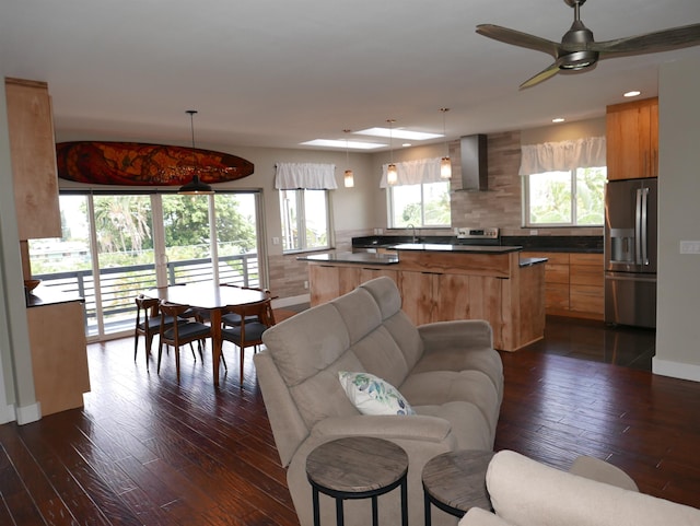 living room featuring ceiling fan, sink, and dark wood-type flooring