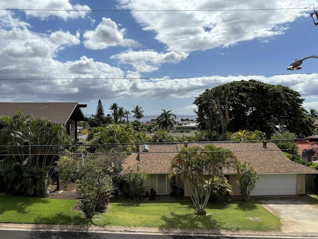 view of front of house with a front yard and a garage