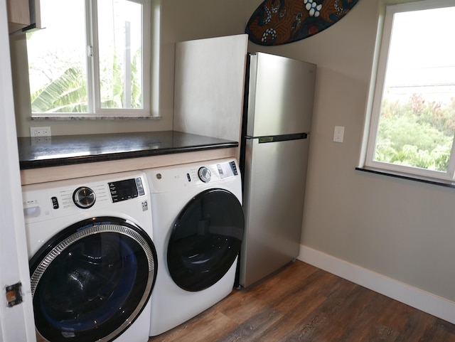 washroom with washing machine and dryer and dark hardwood / wood-style flooring