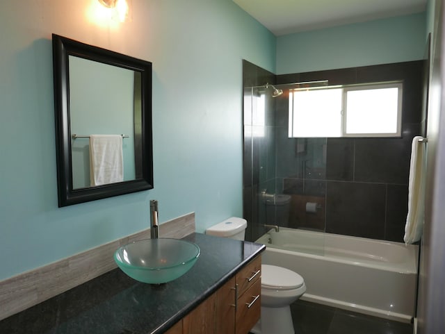 full bathroom featuring vanity, toilet, and tiled shower / bath