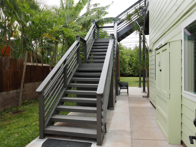 rear view of house featuring a patio area, a balcony, and solar panels