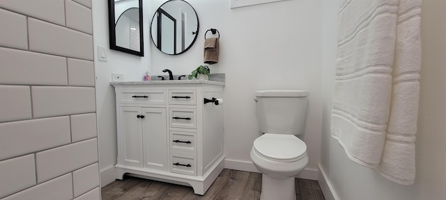 bathroom with vanity, toilet, and wood-type flooring