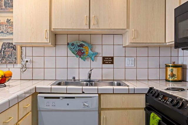 kitchen featuring backsplash, sink, light brown cabinets, and black appliances