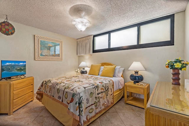 bedroom featuring light tile patterned floors and a textured ceiling