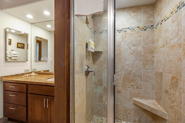 bathroom featuring vanity and an enclosed shower